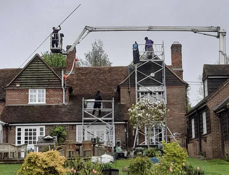 The Moss Cleaners using cherry picker and scaffolding to clean roof safely and professionally in Hedge End, Hampshire